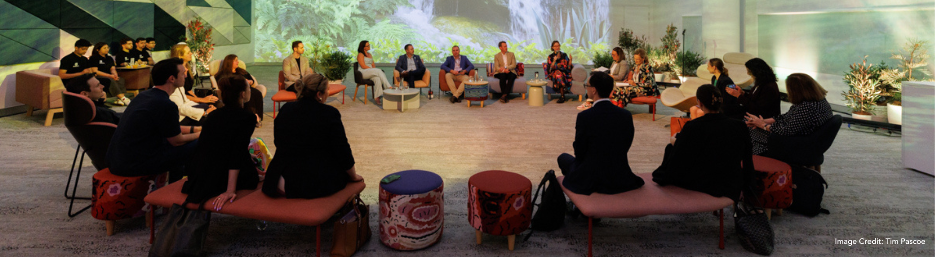 Thumbnail - ICC Sydney's Innovating Events Roundtable, featuring a flowing waterfall projected and a roundtable of participants in ICC Sydney's Convention Centre.