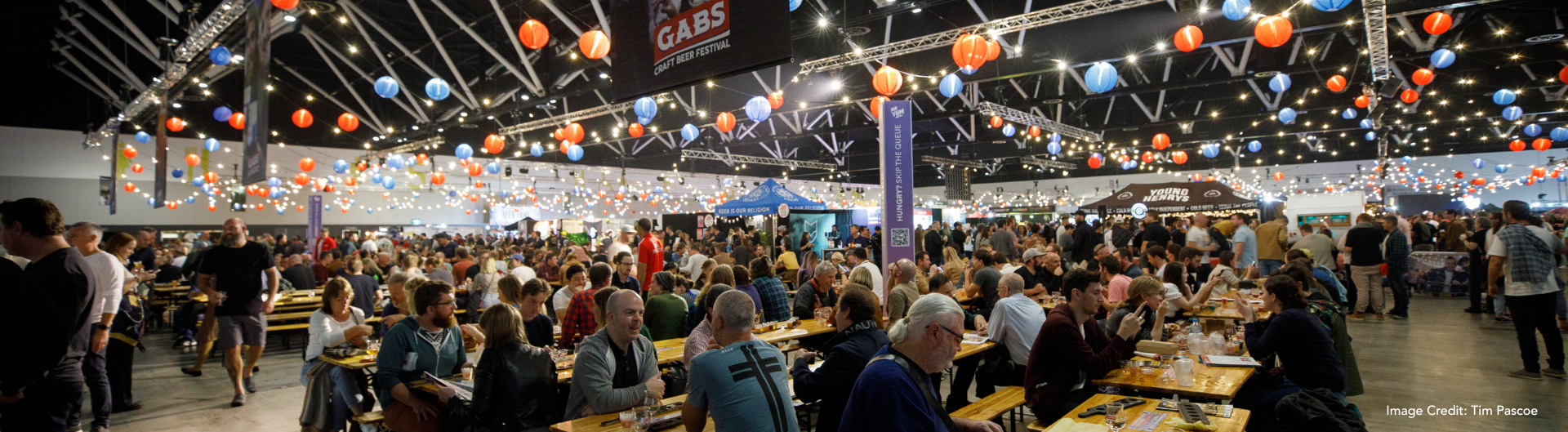 ICC Sydney's GABS festival featuring people drinking on long tables in ICC Sydney's Exhibition Hall.