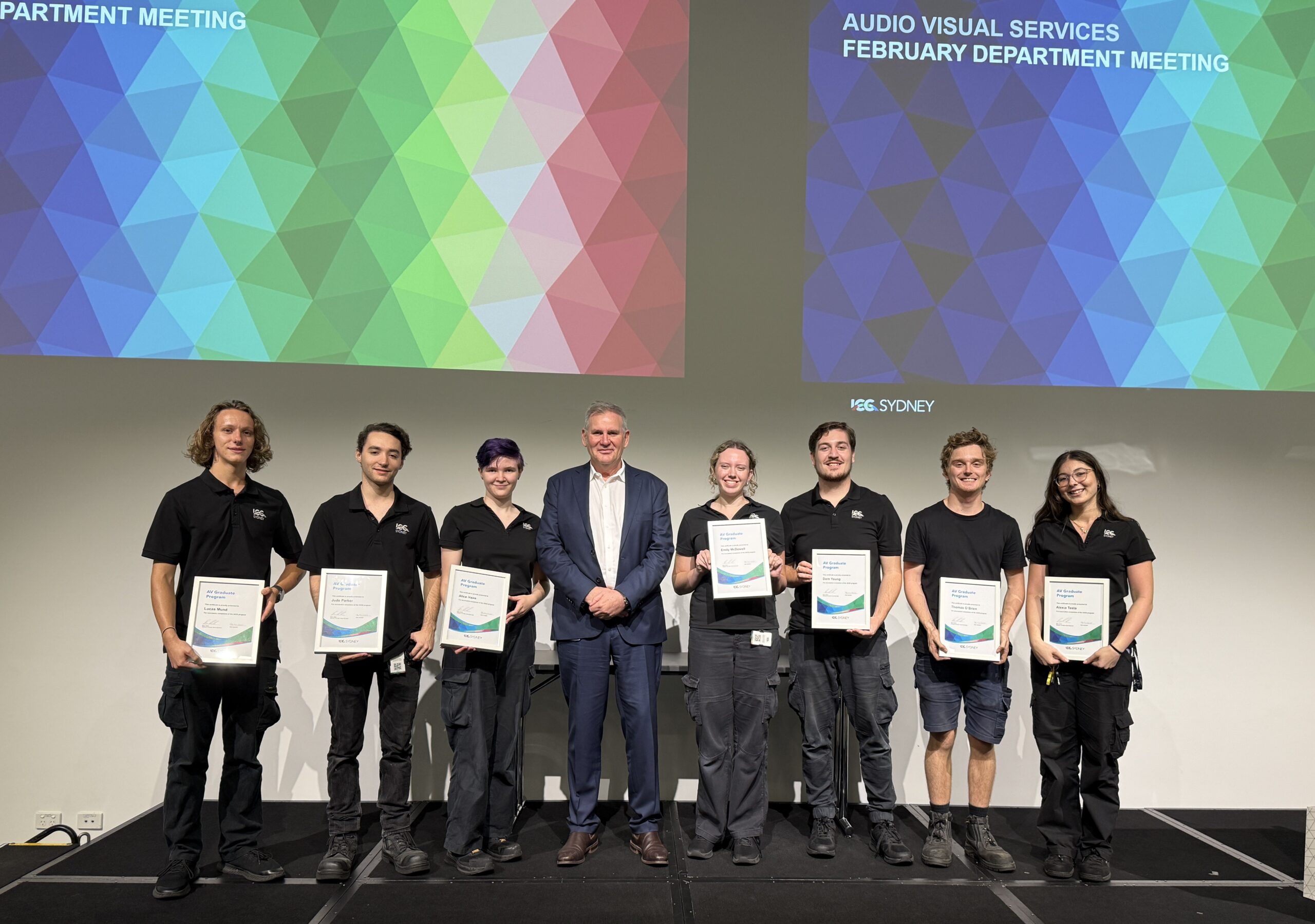 ICC Sydney Audio Visual grads standing with Brain Nash on a stage