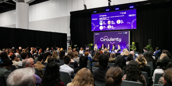 21 ReGEN Expo at ICC Sydney Exhibition hall. Shot taken from slightly above, featuring people looking at a presenter who is discussing circularity