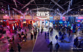 AWS Summit at ICC Sydney's exhibition centre featuring the exhibiiton hall alight with customers and lights.